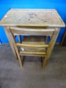 A vintage child's pine desk with a matching chair.