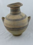 An Antique Cypriot Terracotta Twin Handled Vase, with concentric banding to neck and beneath the