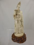 A circa 1900 Japanese Ivory Okimono depicting a Shinto priest, the figure having character marks