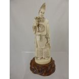 A circa 1900 Japanese Ivory Okimono depicting a Shinto priest, the figure having character marks