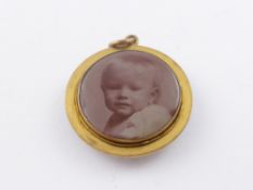 An Edwardian Enamel and Gilt Mourning Locket and Part Gold Chain.