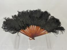 An Early 20th Century Lady's Fan, tortoiseshell effect sticks with Emu feathers.