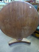 A Victorian mahogany round tilt top table on triple foot base approx 110cm x 72cm.