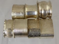 Seven Miscellaneous Solid Silver Napkin Rings, various styles.