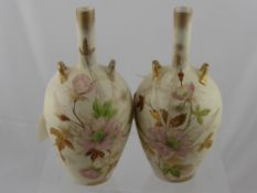 A pair of Victorian slim necked Chinese style vases having floral decoration and two handles, est.