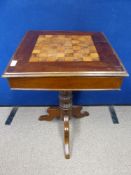 A vintage chess / draughts games table, mahogany with inlaid playing board to the top, turned tripod