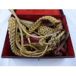 Royal Horseguards Aiguillette and Belt.. A velvet lined metal case with oval brass label Rogers &