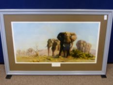 A David Shepherd print depicting a herd of elephants, framed and glazed approx 78 x 39 cms.