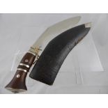 An Antique Chrome Bladed Khukuri Knife. The knife with leather covered sheath and having chrome