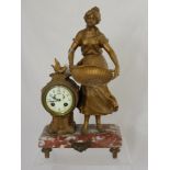 A Victorian marble based mantle clock depicting a farm girl, the clock having a painted porcelain
