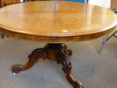 An Antique Round Walnut Tilt Top Table, the table on a ornate bulbous column leading to three highly