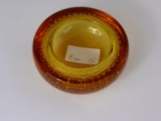 A Whitefriars Amber Ashtray having bubble inclusions.