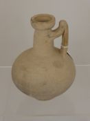 A Small White Ware Roman Jug, everted rim with decorative handle, 17 cms high.