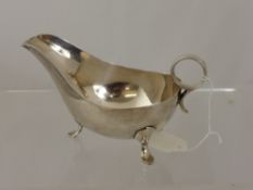 A Solid Silver Sauce Boat,  the sauce boat supported on three hoof feet, Sheffield hallmark, dated
