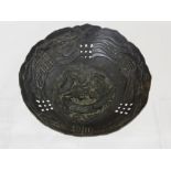 A Chinese silver metal bowl decorated with chasing dragons with character marks to side, est. 10 x