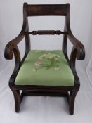An Antique Mahogany Regency child's dining chair. The chair having a floral embroidered seat.