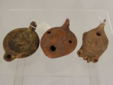 Three Roman Terracotta Oil Lamps, one of typical form depicting a prancing horse, the second