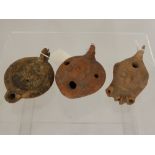 Three Roman Terracotta Oil Lamps, one of typical form depicting a prancing horse, the second