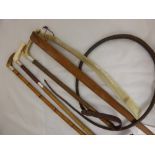 Two Antique Leather and Silver Collared Riding Whips and a silver collared Hunting Whip, with bone