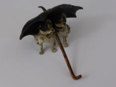 An Antique Cold Painted Bronze Study, of twin dogs seated beneath an umbrella.