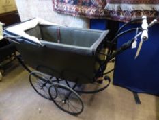 A circa 1910 " Select " pram together with a period umbrella, the pram having pottery handle bars,