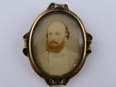 An Edwardian 9ct Gold Tested Portrait Brooch, depicting a bearded gentleman, the frame have scroll