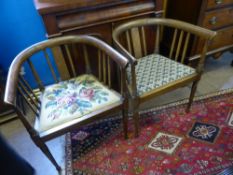 A pair of antique oak tub armchairs being slatted with inlaid decoration, turned front legs, one