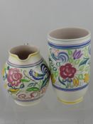Two pieces of Poole pottery comprising a jug and a vase, both having floral decoration (2)