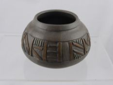 A clay pot decorated with an " Aztec " design, approx. 16 cms. diameter to the body of the pot, 9