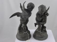 A pair of bronze effect cherubs, one holding a goose, the other a hare, approx. height 27 cms.