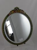 A circular vintage dressing table mirror having bevelled glass, the framed decorated with hand