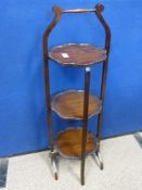 An Edwardian mahogany three tiered cake stand, approx. height 95 cms.