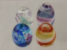 Four Caithness Domed Paperweights, including Feather 2006, Sands of Time, Purple Swirl, Fortune