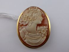 An 18 ct hallmark Shell Cameo Brooch Pendant. The brooch depicting a lady with garlands in her hair,