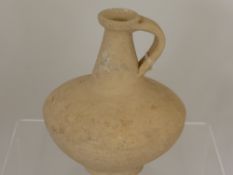 A  Roman White Ware Jug with loop handle and everted rim. First/Second Century AD, 24 cms high.