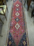 A Vintage Middle Eastern Style Woollen Hall Runner. The Runner having five central ghoul motif