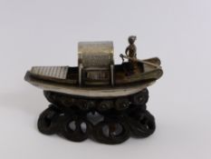 An Antique Silver Chinese Junk, supported on an open work wooden stand, approx 6 cms