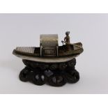 An Antique Silver Chinese Junk, supported on an open work wooden stand, approx 6 cms