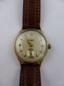 A Gentleman's 9 ct Gold Longines Wrist Watch. The watch having a silvered engine turned face with