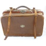 A vintage leather travelling case having a metal plaque to one side  " M Stephan ", the case also