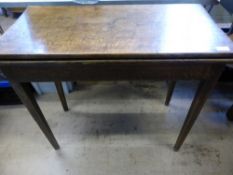 An antique mahogany drop leaf table on turned and ribbed tapered legs, est. 93 x 100 x 77 cms.