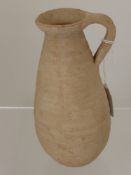 A Romano-Punic 4th Century A.D. Terracotta Buffware Jug, 17 cms high.