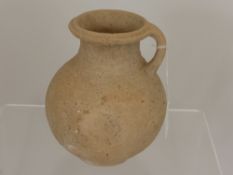 A Roman Earthenware Jug, Eastern Mediterranean with traces of incised decoration, Second/Third