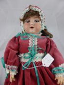 An Armand and Marseille Porcelain Headed Doll, nr 390-A 6.1/2 M, the doll having an open mouth and