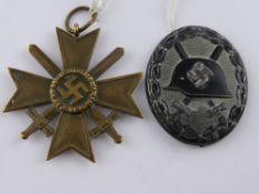 A German WWII Wound Badge together with Nazi Merit Cross (2)