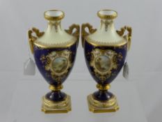 A Pair of Coalport Pedestal Vases, with vignettes of landscape views by Percy Simpson, twin