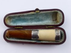 A Silver and Amber Cigarello Holder, Birmingham hallmark, dated 1899.