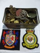 A Tin Box containing miscellaneous military buttons and cap badges, including North Stafford,