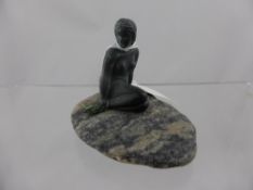 A metal figure of " The Little Mermaid " seated on a stone base, approx. 8 cms. high including the