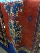 A Vintage Middle Eastern Style Woollen Rug. The rug having red and blue background with three